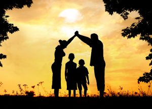 Silhouette, group of happy children playing on meadow, sunset, summertime to illustrate the importance of estate planning
