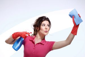 young housewife exercising while cleaning on white