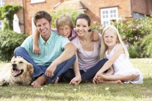 Family Sitting In Garden Together with a dog | adopt a dog
