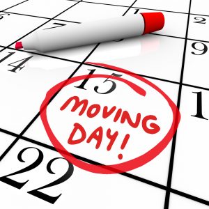 The words Moving Day and a date circled on a calendar with a red marker to illustrate a reminder of an important time for relocation to a new home or place of business to illustrate moving advice